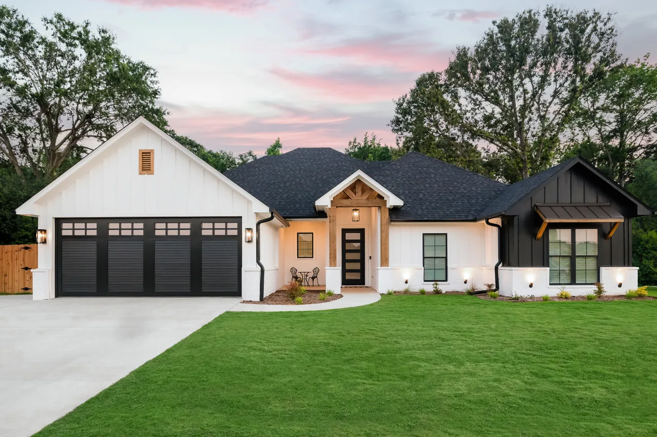Clopay Canyon Ridge louver door in black on a white farmhouse
