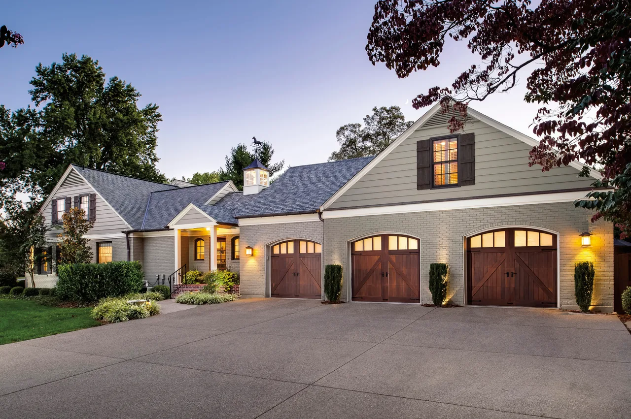 Clopay Reserve Wood limited-edition doors on a brick house at dusk