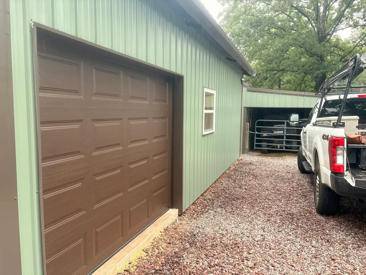 A brown door on a green metal building