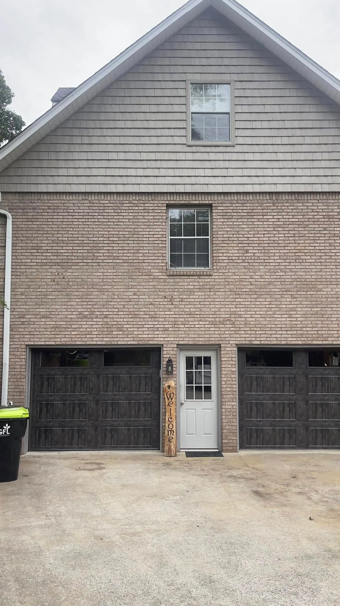 Two dark doors on a brick house