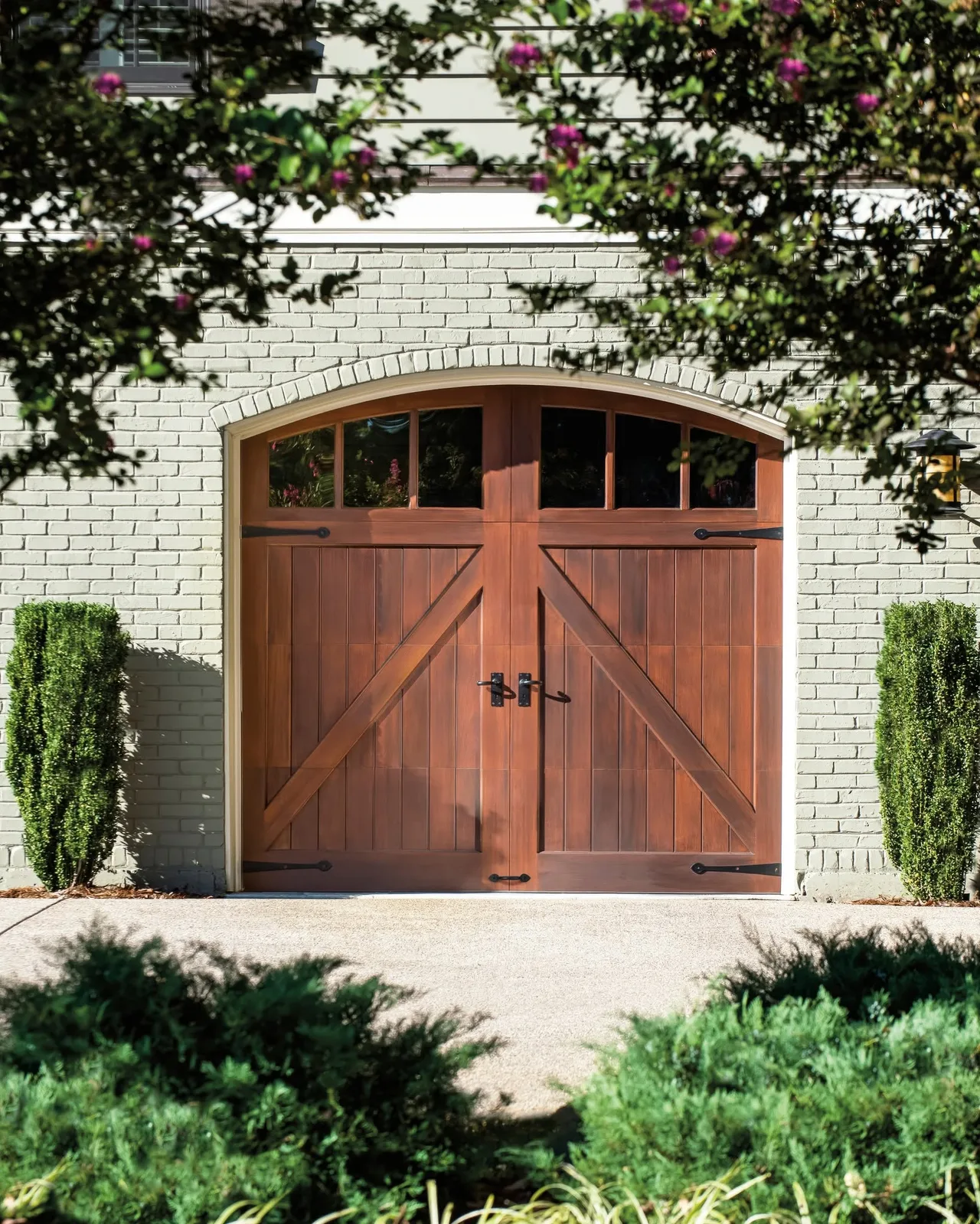An arched carriage door in a stone opening