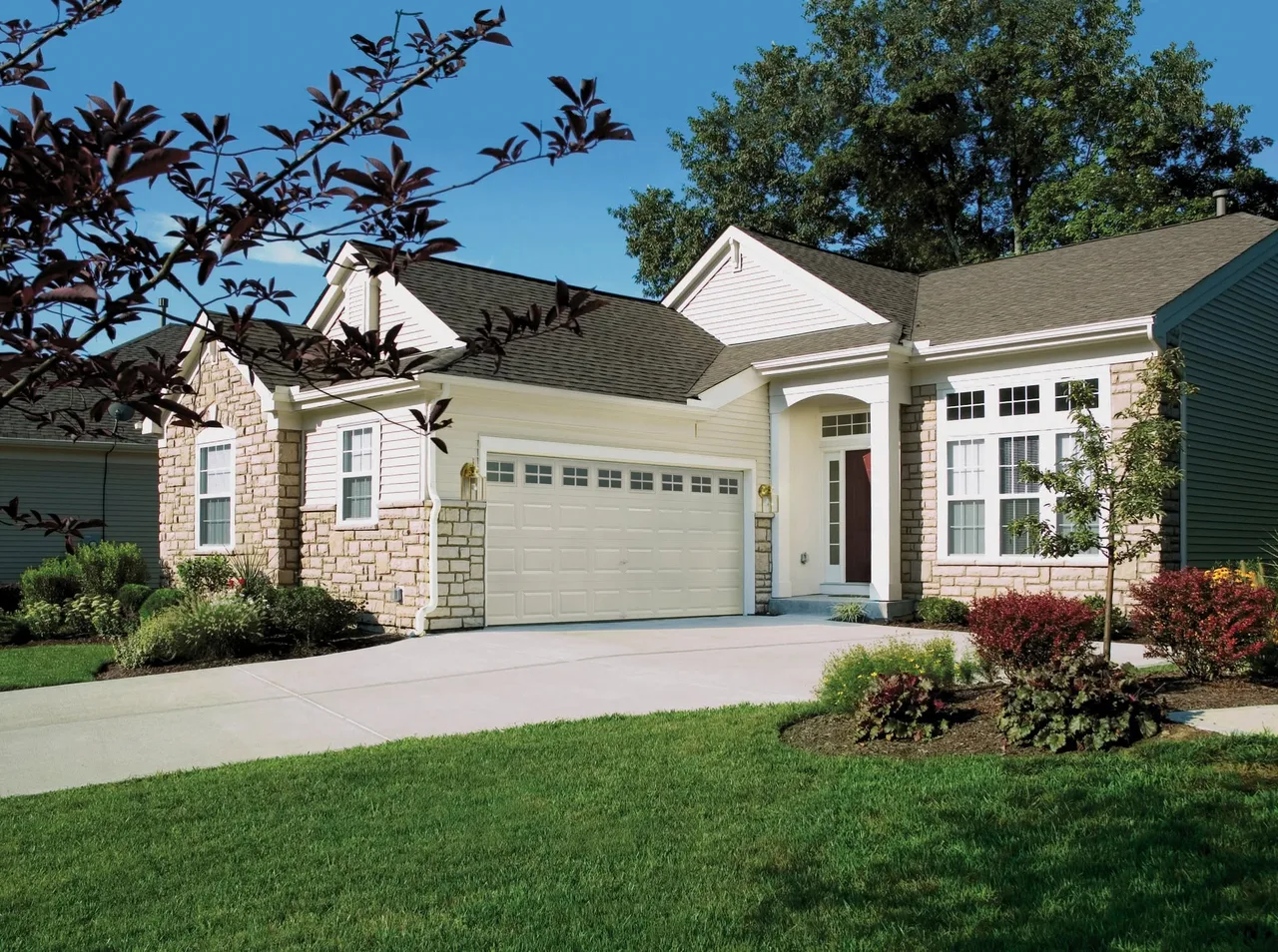A white door on a stone and siding house