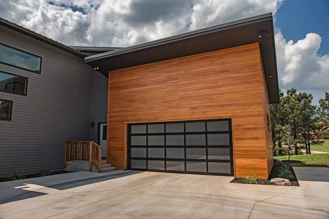 A glass door on a wood-clad house
