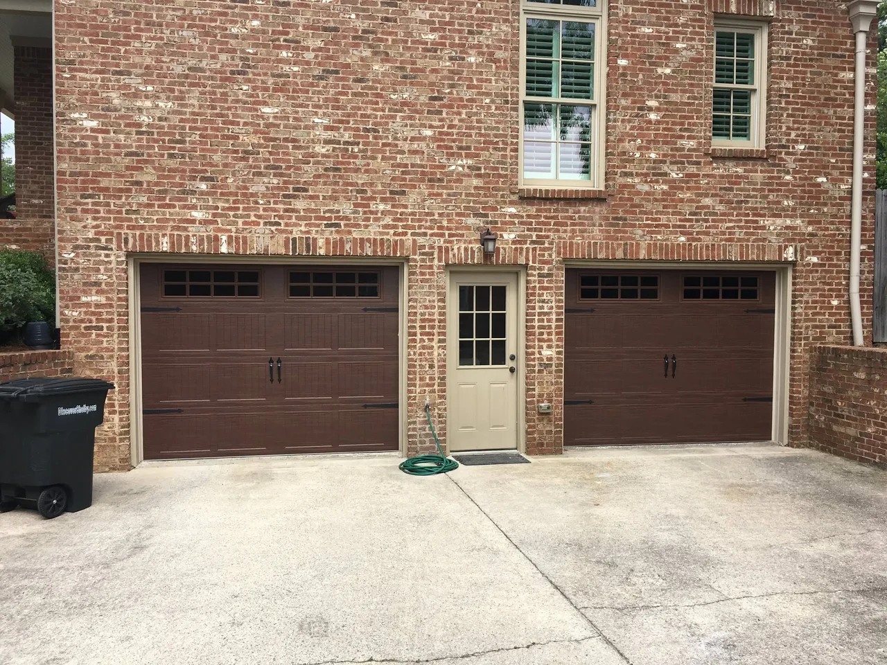 Two pairs of carriage doors on brick